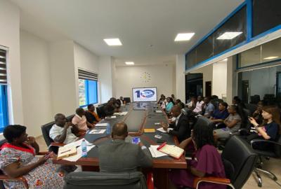 ACECoR-CCM team seated around a long conference table having a discussion about the strategies for the year.